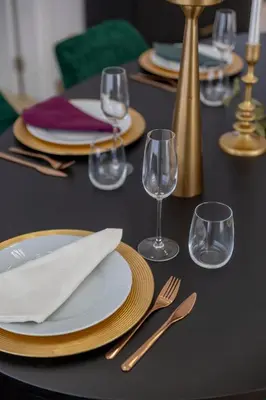 a black table with plates and forks and wine glasses at Villa Velluto in Albufeira