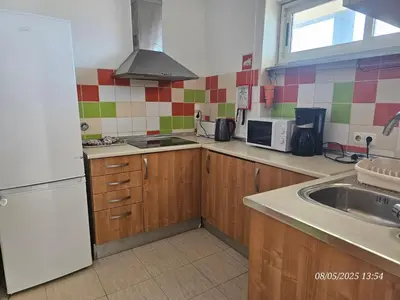 a kitchen with a white refrigerator and a sink at Blife Vistaya private rooms at Faro beach in Faro