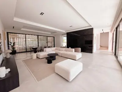 a living room with white furniture and large windows at Villa São Rafael in Albufeira