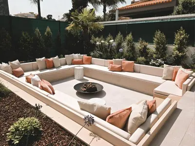 a patio with a long white couch and pillows at Villa São Rafael in Albufeira