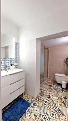 a bathroom with a sink and a toilet at Lazaro Beach House in Faro