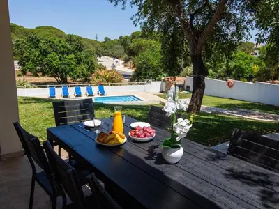 a wooden table with a bowl of fruit on it at Vila Paço no Vale by Stay ici Algarve Holiday Rental in Albufeira