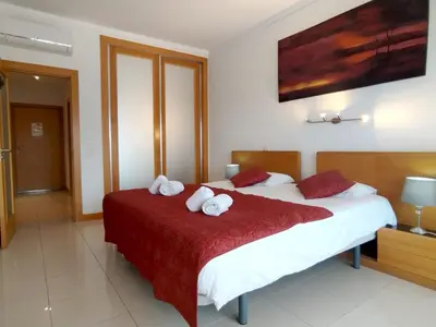 a bedroom with a bed with towels on it at Barracuda dom in Albufeira