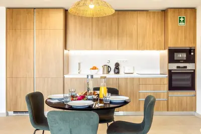 a dining room with a table and chairs in a kitchen at Modern 1-Bed Apartment with Terrace Albufeira in Albufeira
