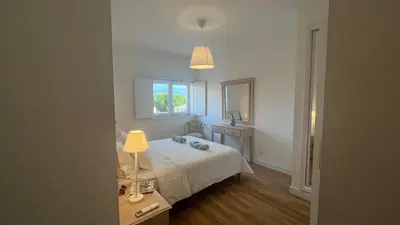 a bedroom with a white bed and a window at Blue Wave Albufeira in Albufeira