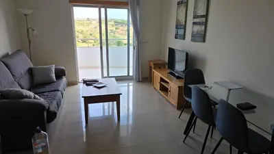 a living room with a couch and a table and a television at Monte da Eira apt 62 in Albufeira