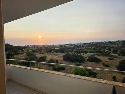 a balcony with a view of the sunset at Monte da Eira apt 62 in Albufeira