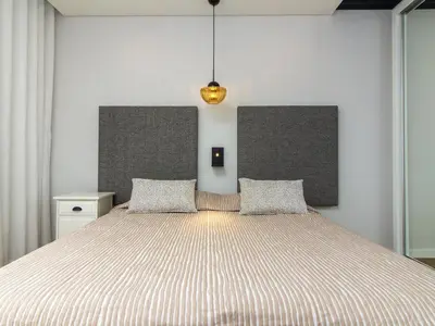 a living room with a couch and a large window at Oásis Apartment by Stay ici Algarve Holiday Rental in Albufeira