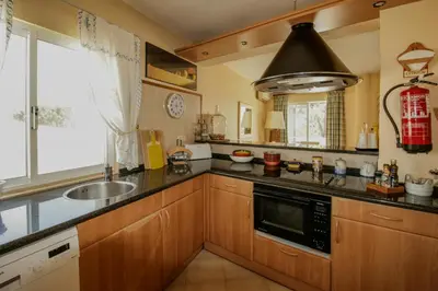a kitchen with a sink and a microwave at FLH Quinta do Lago Retreat with Terrace & Pool in Almancil