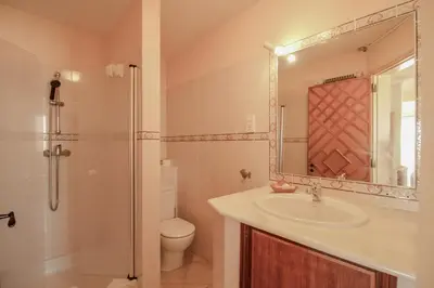 a bathroom with a sink and a toilet and a mirror at FLH Quinta do Lago Retreat with Terrace & Pool in Almancil