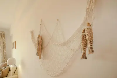 a white hammock hanging on a wall at FLH Quarteira Seaview in Quarteira