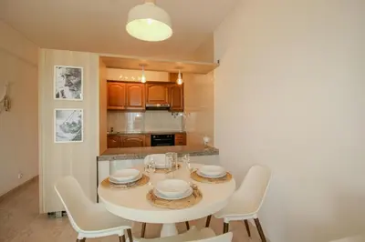 a dining room with a white table and chairs at FLH Quarteira Seaview in Quarteira