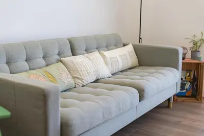 a couch with pillows on it in a living room at Garret - Faro Apartment by HD in Faro