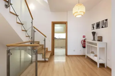 a hallway with a glass staircase in a house at Villa da Ria - by HD Properties in Monte Negro