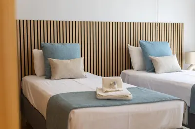 two beds with a hat on top of them at Villa da Ria - by HD Properties in Monte Negro