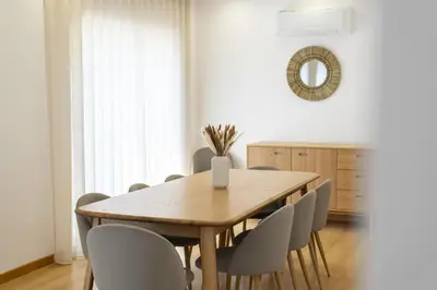 a dining room with a wooden table and chairs at Villa da Ria - by HD Properties in Monte Negro