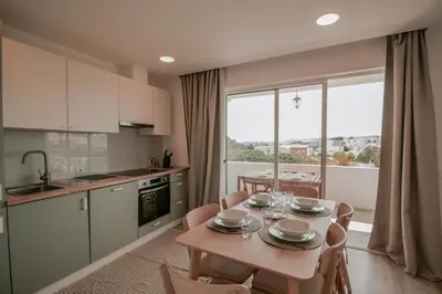 a kitchen and dining room with a table and chairs at FLH Albufeira Boho Chic with Balcony in Albufeira
