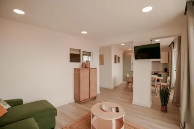 a living room with a couch and a table at FLH Albufeira Boho Chic with Balcony in Albufeira