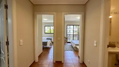 a hallway with a room with two beds and a bathroom at Sun by Check-in Portugal in Albufeira