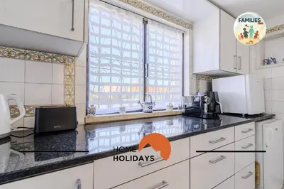 a kitchen with a black counter top and a window at #329 Families Only - Jacaranda by Home Holidays in Albufeira