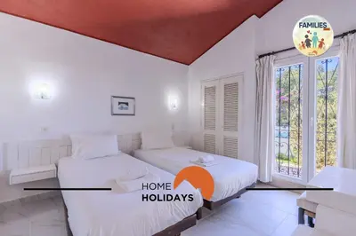 two beds in a white room with a window at #329 Families Only - Jacaranda by Home Holidays in Albufeira