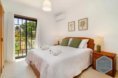 a bedroom with a bed with two towels on it at O Mar - Dream Lodging in Olhos de Água