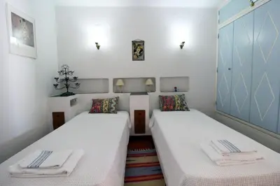 two beds in a small room with white walls at V2 - Aldeia do Golfe B2 in Quarteira