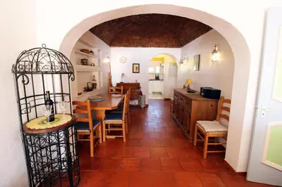 a kitchen and dining room with a table and chairs at V2 - Aldeia do Golfe B2 in Quarteira