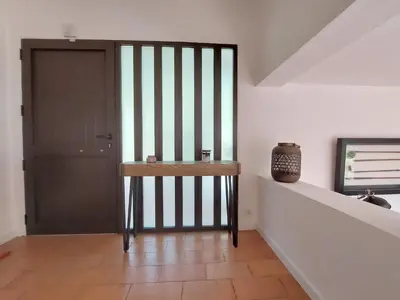 a hallway with a door and a vase on a shelf at V2 - Bungalow 12 in Quarteira