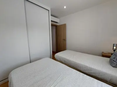 two beds in a small room with white walls at V2 - Bungalow 12 in Quarteira