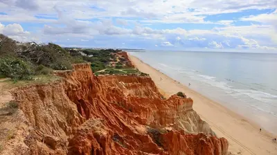 a view of a sandy beach and the ocean at T1 in Albufeira near Alfamar Hotel in Albufeira