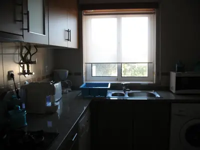 a kitchen with a sink and a window at T1 in Albufeira near Alfamar Hotel in Albufeira