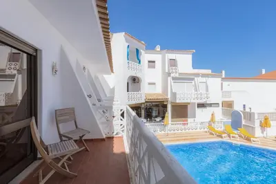 a balcony of a building with a swimming pool at Beachtime - Oura Beach Apartment in Albufeira