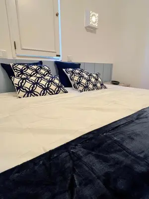 a bed with three pillows on top of it at Delta Marina Vilamoura in Quarteira