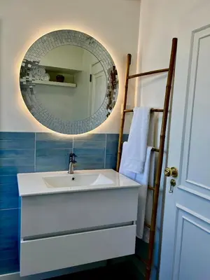 a bathroom with a sink and a mirror at Delta Marina Vilamoura in Quarteira