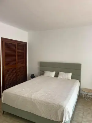 a bedroom with a large bed with two pillows at Apartamento em São Rafael in Albufeira