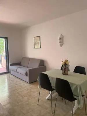 a living room with a table and a couch at Apartamento em São Rafael in Albufeira