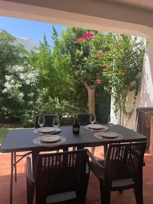 a black table with two chairs and wine glasses at Apartamento em São Rafael in Albufeira