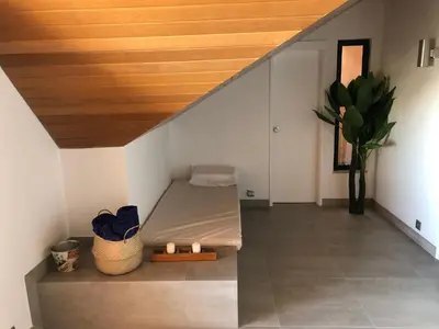 a room with a bed under a staircase at Beach Apartment Marina Vilamoura in Vilamoura