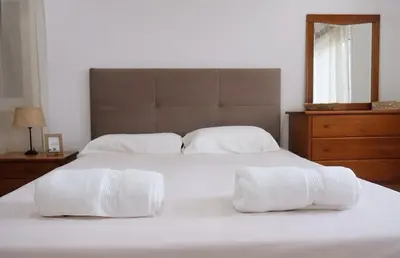 a white bed with two white towels on it at Bloom Place VALE DO LOBO - Apartamento acolhedor com terraço in Vale do Lobo