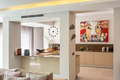 a kitchen with a painting of a cow on the wall at Deluxe Ancao in Almancil