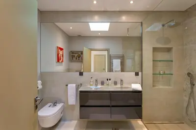 a bathroom with a sink and a toilet and a mirror at Deluxe Ancao in Almancil