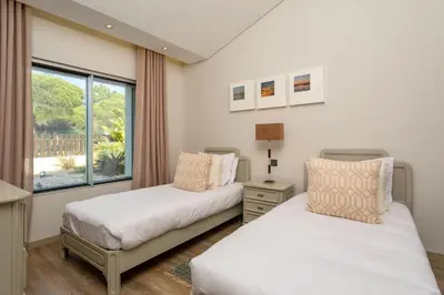 two beds in a room with a window at Deluxe Ancao in Almancil