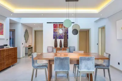 a dining room with a wooden table and chairs at Deluxe Ancao in Almancil