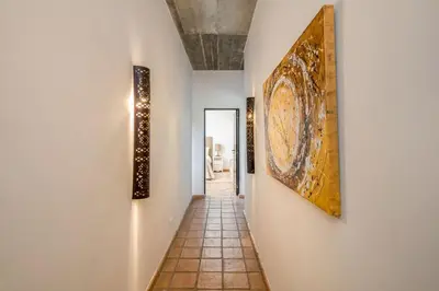 a hallway with paintings on the walls of a house at Villa Zambujal in Boliqueime