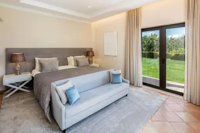 a bedroom with a bed and a couch at Villa Zambujal in Boliqueime