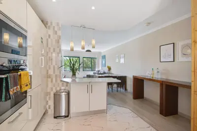 a kitchen and dining room with a table and a counter at Salgados Beach House in Albufeira