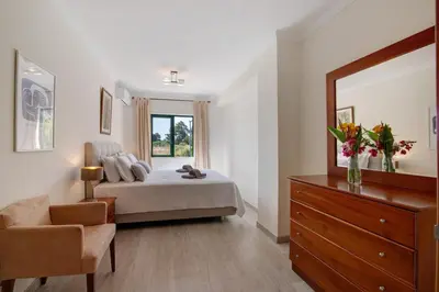 a living room with a table and a dining room at Salgados Beach House in Albufeira