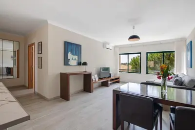 a living room with a couch and a table at Salgados Beach House in Albufeira