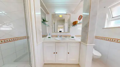 a bathroom with a sink and a mirror at Villa Sunset,sleeps 9,heatable pool,walk to marina in Vilamoura